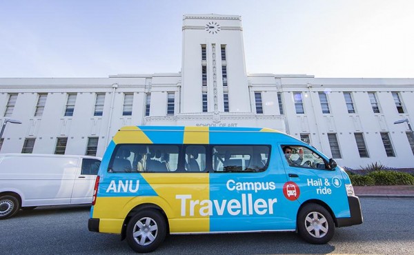 Blue and yellow ANU Campus Traveller Bus in front of Old Parliament House