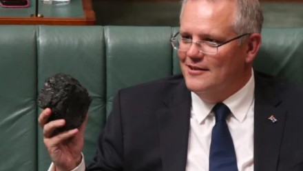 Scott Morrison sitting in the House of Representatives, holding a lump of coal.