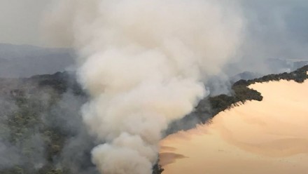 An aerial photograph of smoke plumes rising from the fire at Fraser Island in December 2020.
