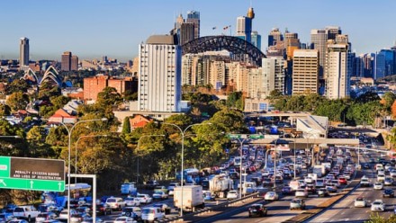 A photograph of Sydney City on a sunny day, looking towards the Sydney Harbour Bridge.