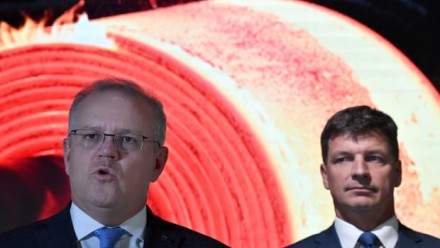 A photograph of Scott Morrison giving a presentation, with Angus Taylor standing behind him to his right.