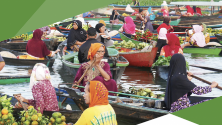 A river filled with boats rowed by women, filled with their farm produce