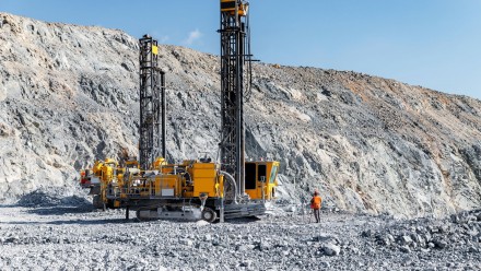 Open pit mine gold ore industry. Massive Mining Dump Truck and Drilling Equipment at Quarry Site