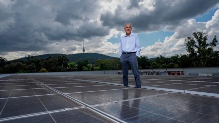 Photo of Prof Andrew Blakers next to solar panels