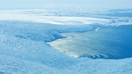 An aerial view of an area where the Antarctic Ice Sheet meets the sea.