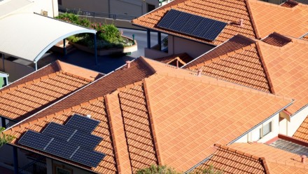 Aerial photo of two house rooftops with solar panels