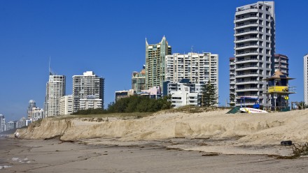 A photograph of sky rise towers at Surfers Paradise, with coastal erosion bringing the beach up within metres of the buildings.