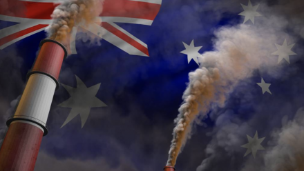 Coal-fired power station chimneys superimposed over the Australian flag.
