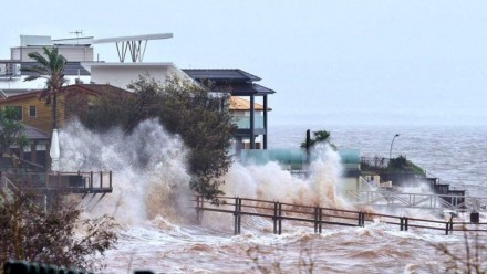 Waterfront homes at Scarborough in the Moreton Bay region being lashed by wild weather and big swells. 