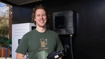 Dr Bjorn Sturmberg standing next to an EV charger station