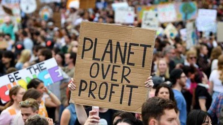 A sign reading 'Planet over profit' is held up at a Global Strike 4 Climate rally in Melbourne in September 2019.