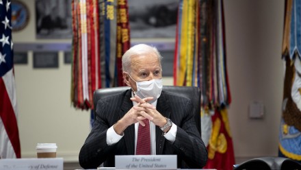 US President Joe Biden seated at a desk