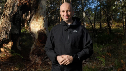 NSW Environment Minister Matt Kean standing in front of an area of bushland