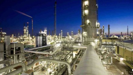 An aerial photograph of an energy production facility at night time.