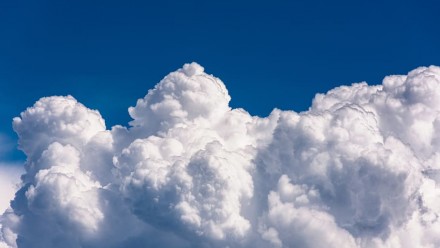 Fluffy clouds in a blue sky.