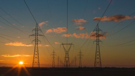 Transmission poles and wires at sunrise