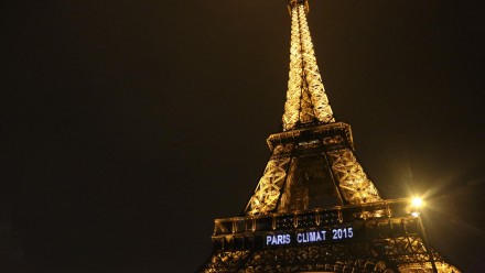 The Eiffel Tower at night, with the words 'Paris Climat 2015' lit up on it.
