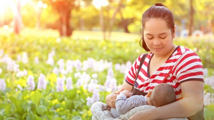 Woman breastfeeding small infant shuttestock