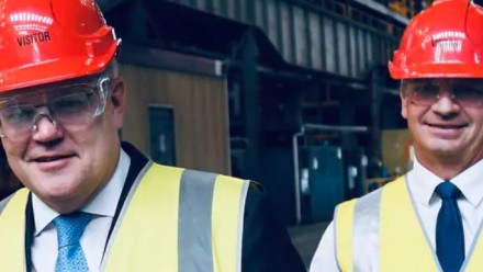 Prime Minister Scott Morrison and Minister for Energy and Emissions Reduction Angus Taylor in red hard hats and neon yellow safety vests.
