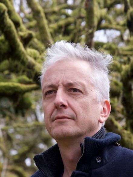 A photograph of Prof Tim Denham outside, looking towards the left of the camera.