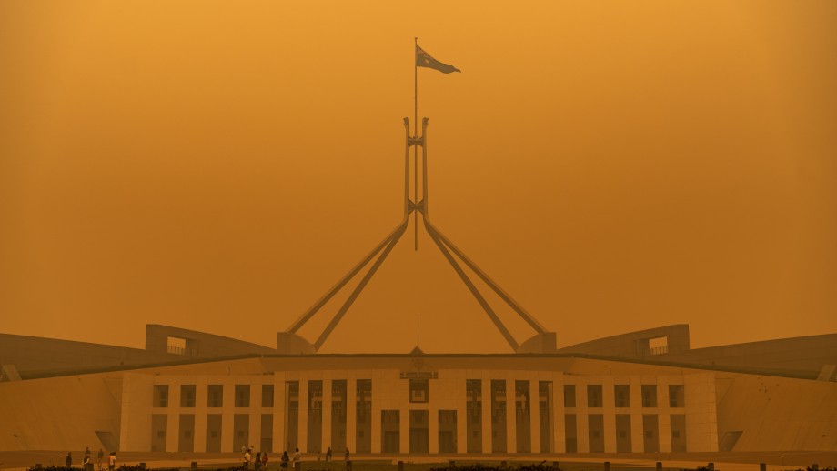 A dense orange haze of bushfire smoke covers Australian Parliament House during the 2019-20 Black Summer Bushfires.