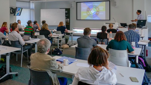 Climate Essentials one-day professional short course participants look at a presentation in a classroom